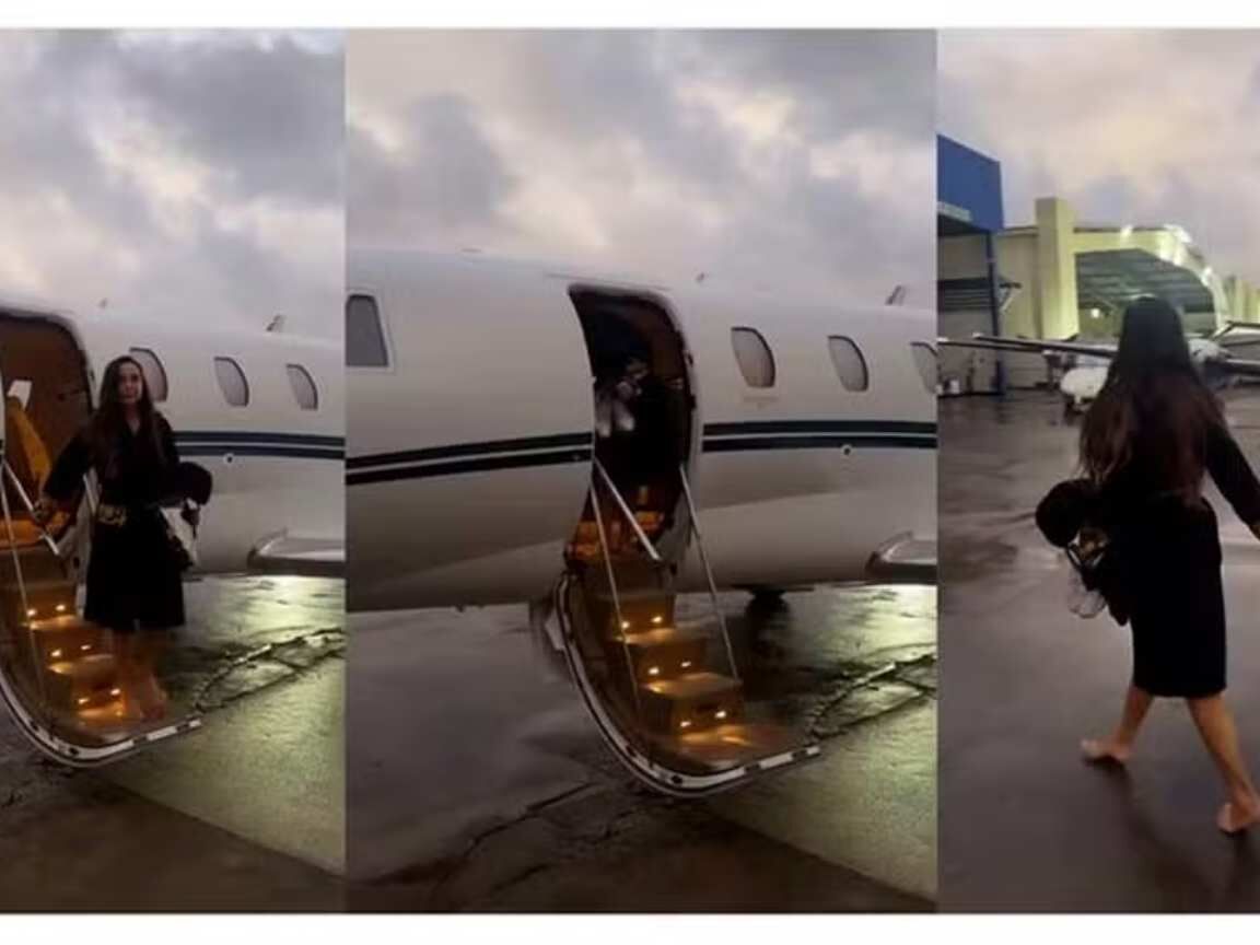 Ivete Sangalo desce de jatinho de roupão e pulando em poças d'água